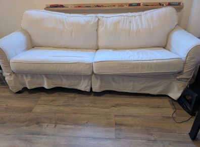 White sofa bed with pull-out mattress