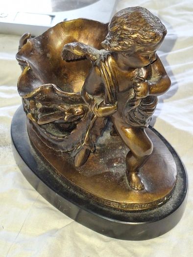 Bronzed Winged Cherub putto open seashell or leaf-shaped vessel with a scorpion like tail.