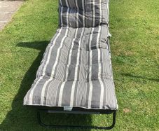 Sunbed and padded cushion