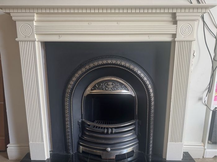 fireplace wooden surround and cast iron back plate