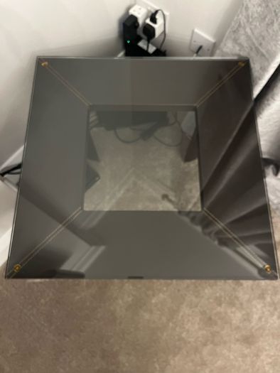 Square Glass coffe table with brown leather upholstery
