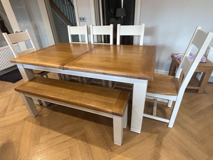 Large extendable 8 seater table with 5 chairs and a bench