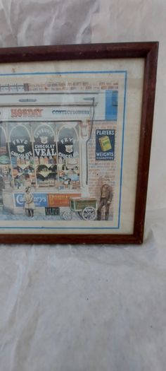 Old advertising shop front picture print ,different brands for sale, in the shop,nice for any home bar or man cave pub restaurant etc,,buyer collects thank you,, rather buyer collects with the glass ,sold as is ,,see pictures for condition