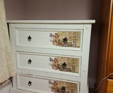 Wooden chest of drawers with floral detail
