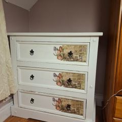 Wooden chest of drawers with floral detail