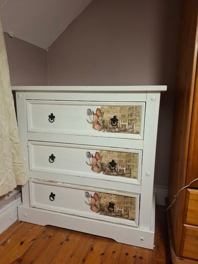 Wooden chest of drawers with floral detail