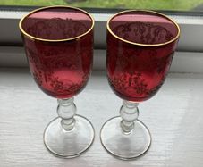 Pair of cranberry glass gold etched antique wine glasses