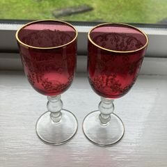 Pair of cranberry glass gold etched antique wine glasses