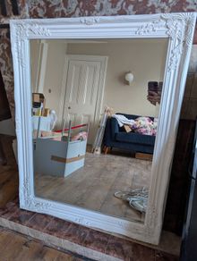 Ornate white wall mirror