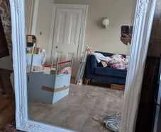 Ornate white wall mirror