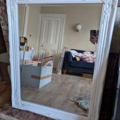 Ornate white wall mirror