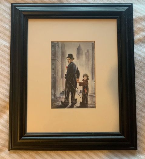 Framed pictures of Charlie Chaplin & Laurel and Hardy