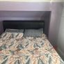 king size bed with black leather head board Image 2