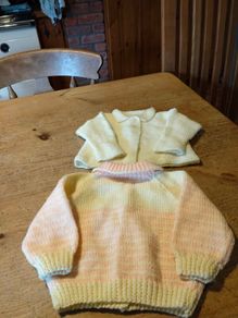 Baby Handkitted cardigans, one pink and yellow. And one plain yellow. New never worn.
