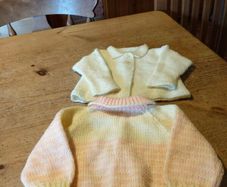 Baby Handkitted cardigans, one pink and yellow. And one plain yellow. New never worn.