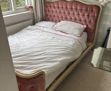 Antique double bed with pink velvet