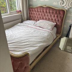 Antique double bed with pink velvet