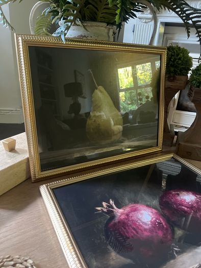 Two gold framed fruit prints.