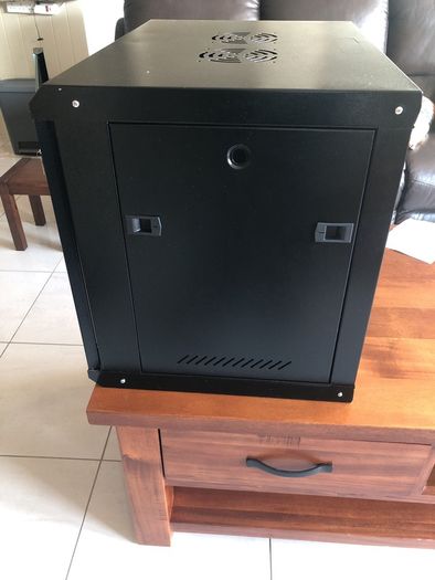 Cams wall mounted 9U cabinet with a variety of cables and connections