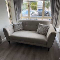 Modern two-seater sofa in light grey fabric