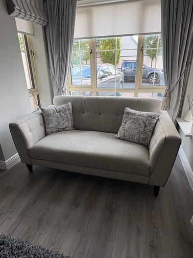 Modern two-seater sofa in light grey fabric
