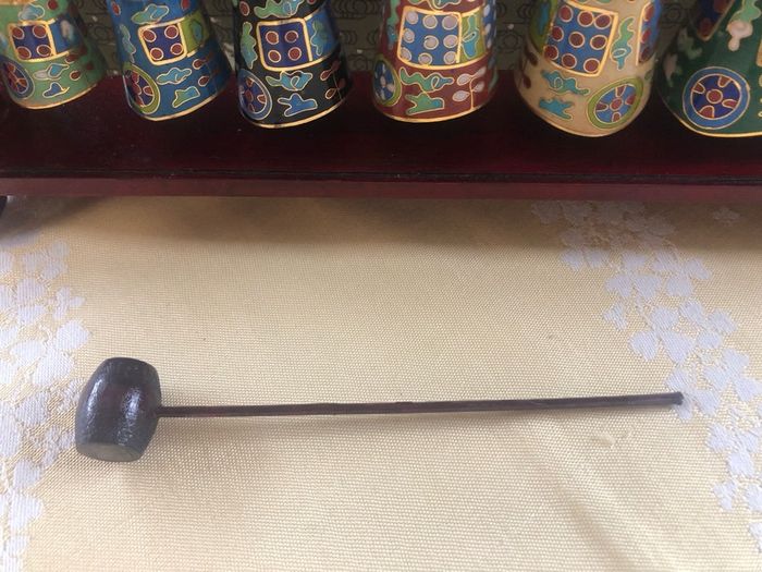 Enamel cloisonne graduated bells on wooden stand