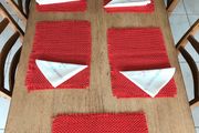 6 red woven place mats and 4 napkins