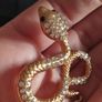 A striking snake-shaped brooch. Image 6