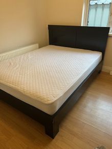 Solid black wooden kingsize bed