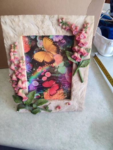 BUTTERFLIES picture framed in stone finish frame edged with flowers.