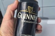 vintage Guinness Radio Can shaped like a can with a telescoping antenna