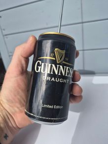 vintage Guinness Radio Can shaped like a can with a telescoping antenna
