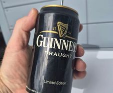 vintage Guinness Radio Can shaped like a can with a telescoping antenna