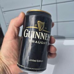 vintage Guinness Radio Can shaped like a can with a telescoping antenna