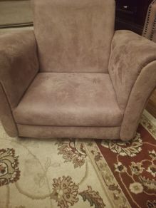 Baby chair. beige fabric armchair resembles the Rosebury model from EZ Living Interiors, featuring a low-profile design and soft textured upholstery.