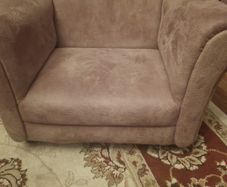 Baby chair. beige fabric armchair resembles the Rosebury model from EZ Living Interiors, featuring a low-profile design and soft textured upholstery.