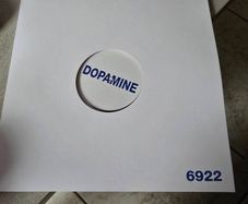 This product is a first pressing of Fontaines DC's album "Dopamine Chamber" on white vinyl in a cardboard sleeve. The record is in mint condition and features stereo audio channels. This limited edition LP was released in 2026