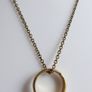 Vintage necklace features a polished, knocker-shaped pendant  gold plated, centered with an iridescent turquoise Spinning Fob Image 7