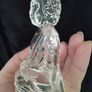 A glass Buddha figurine seated in the lotus position. Image 6