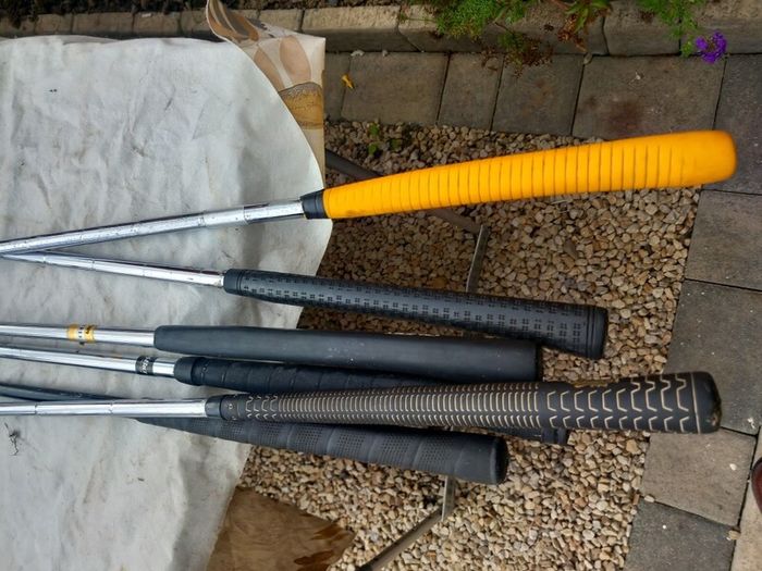 A selection of Golf clubs. Bags and golf balls.