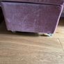 pink velour covered stool with interior storage space moves easily on castors Image 3