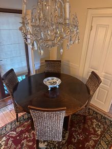 Walnut veneer dining table and four rattan dining chairs