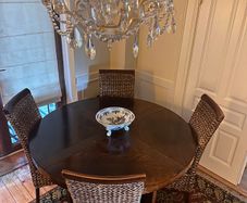 Walnut veneer dining table and four rattan dining chairs
