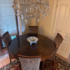 Walnut veneer dining table and four rattan dining chairs