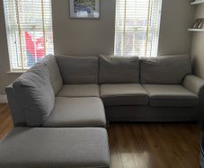 Corner sofa with footrest
