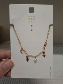 Golden necklace with charms