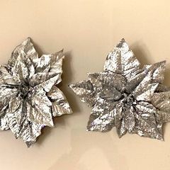 Two silver glitter poinsettia Christmas tree decorations