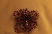 Beaded copper colour brooch