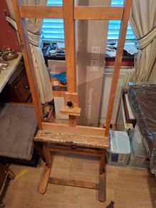Easel And Selection Of Paints And Book