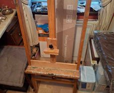 Easel And Selection Of Paints And Book